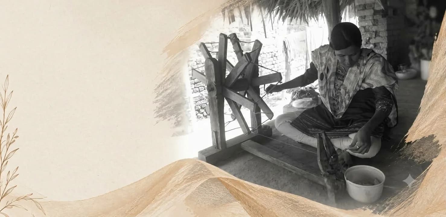 Artisan spinning thread on a wooden charkha